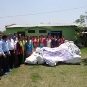 13640922_1023965721034711_5334109757393920399_o Rotarians and community members with relief supplies outside a school