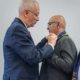 A ceremonial pin presentation during the Rotary Club of Patan installation programme