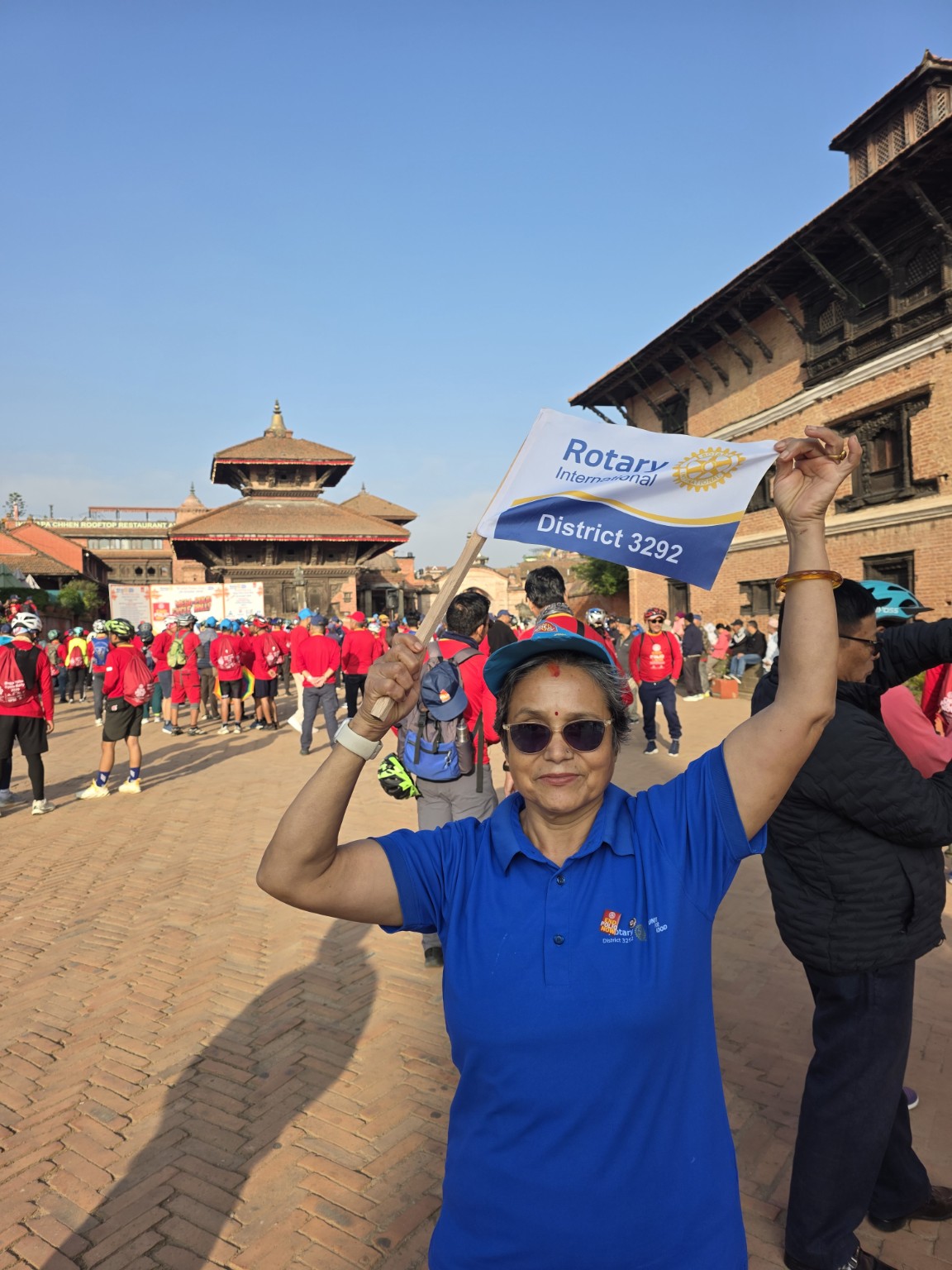 Rtn. Maheswari Bisht Rawal of the Rotary Club of Patan holds the Rotary District 3292 flag at Bhaktapur Durbar Square during the World Polio Day rally inauguration on 24 October 2026.