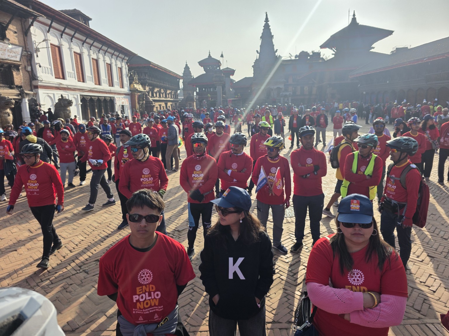Cyclists and supporters gather in End Polio Now shirts at Bhaktapur Durbar Square.