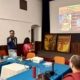 Presentation and discussion during Faces of Buddha at Rotary Club of Patan, with Buddha paintings displayed, 12 October 2026.