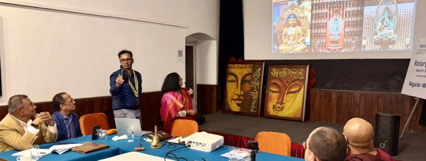 Presentation and discussion during Faces of Buddha at Rotary Club of Patan, with Buddha paintings displayed, 12 October 2026.