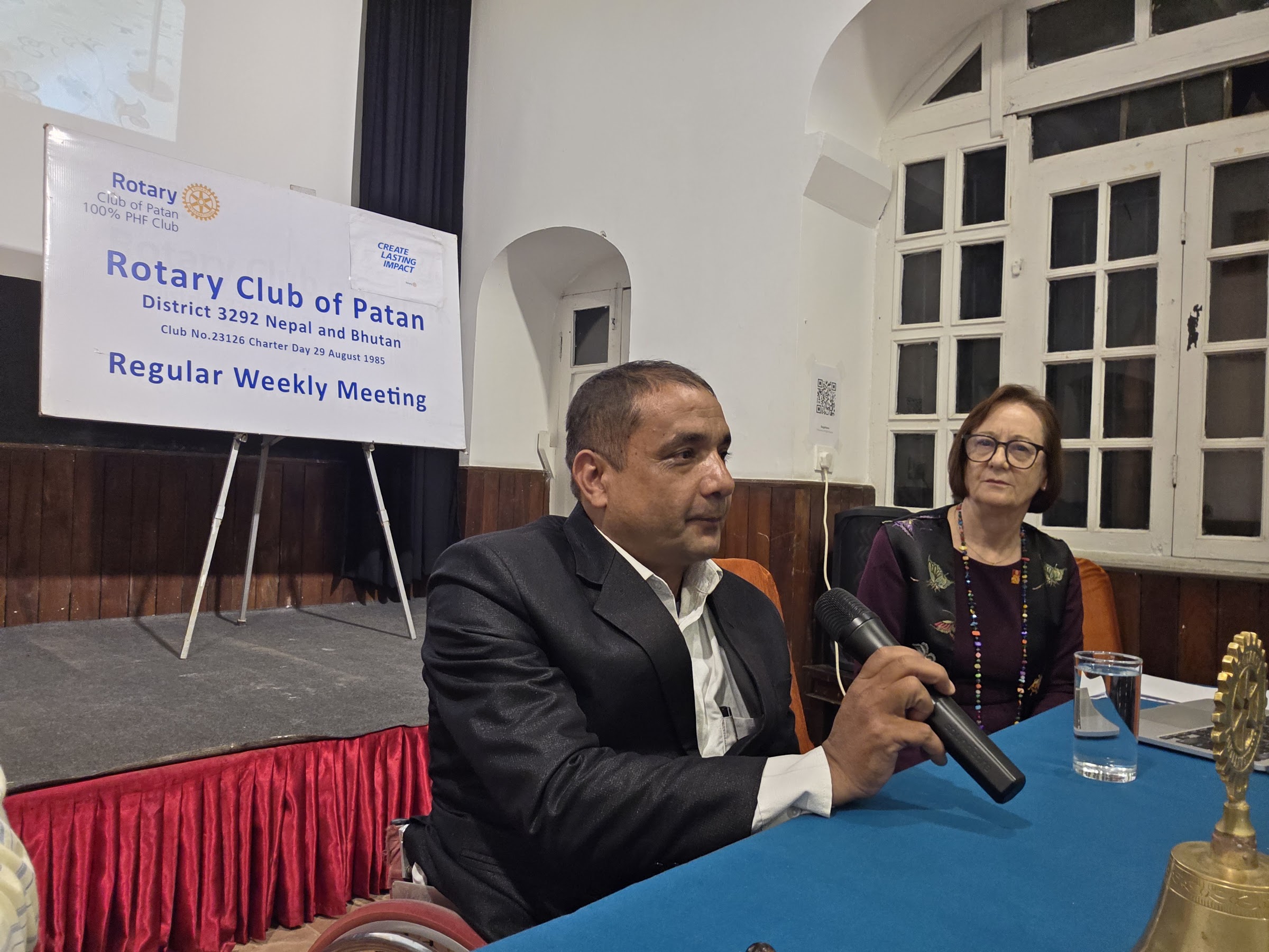 A speaker addresses members during the question-and-answer session at the World Polio Day meeting.