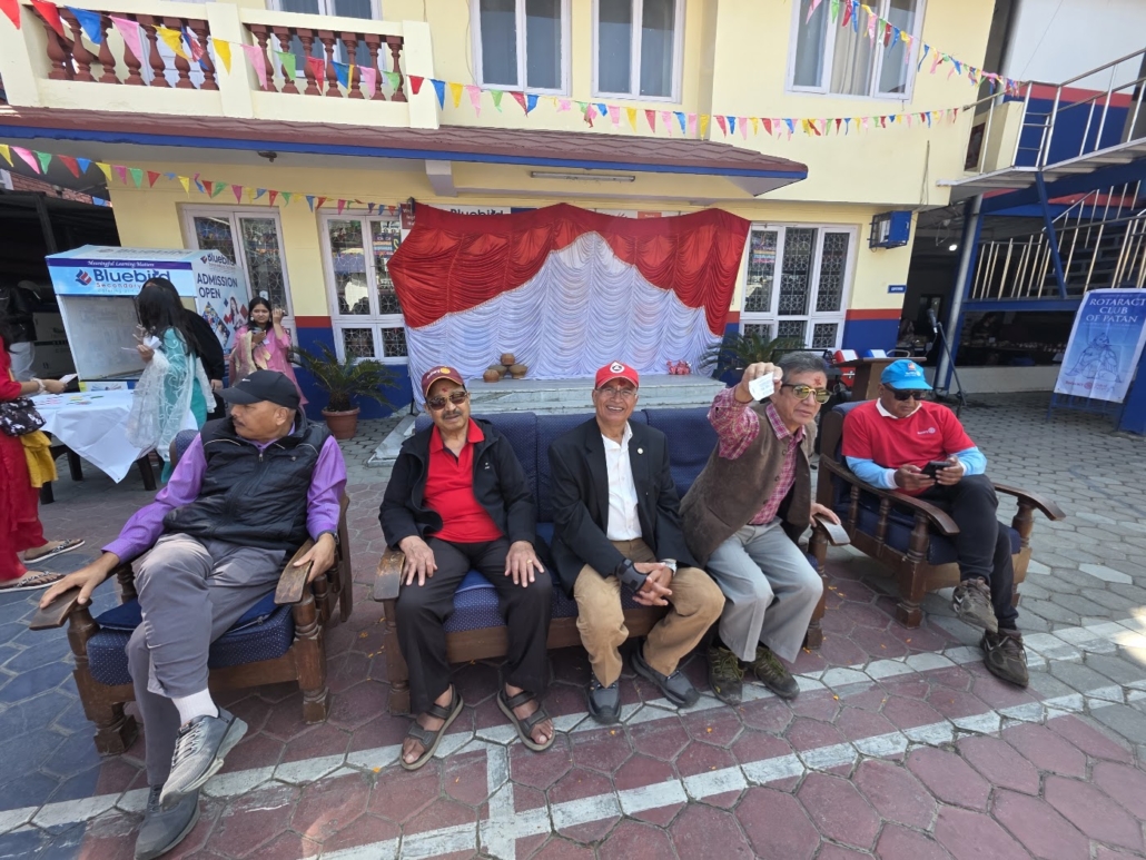 Rotarians enjoy the morning programme in the courtyard of Bluebird Secondary School.